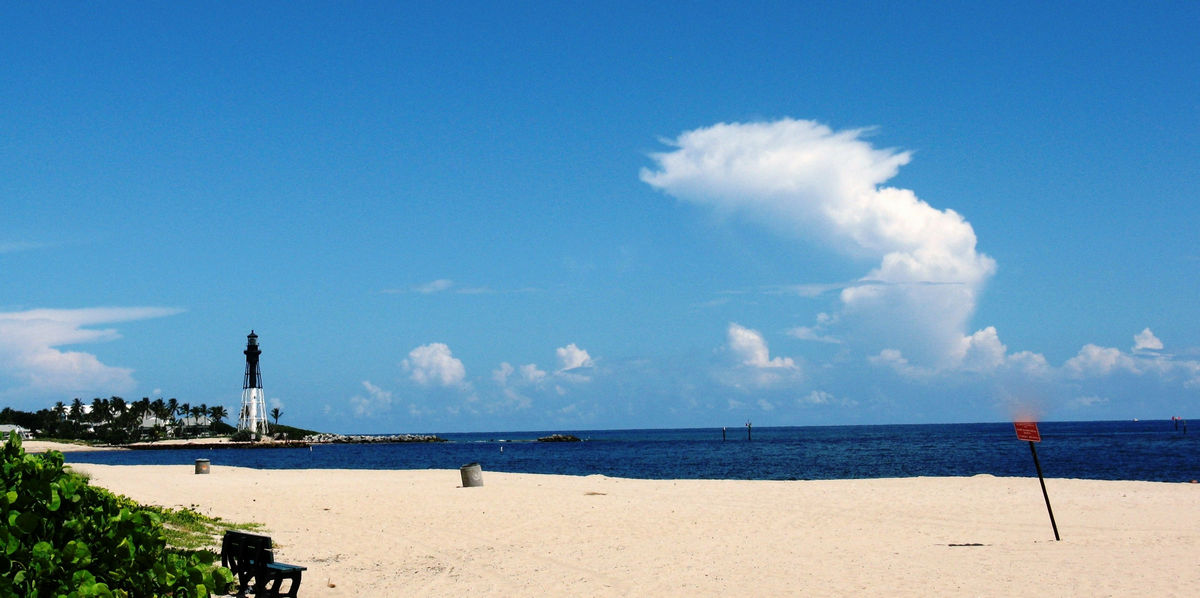 A view of the beach and Deerfield Beach lighthouse at Hillsboro Inlet, Pompano Beach Florida